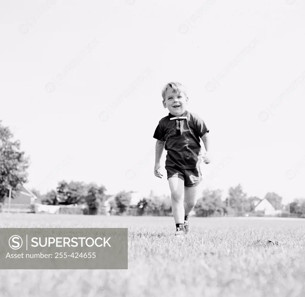 Little boy walking on field