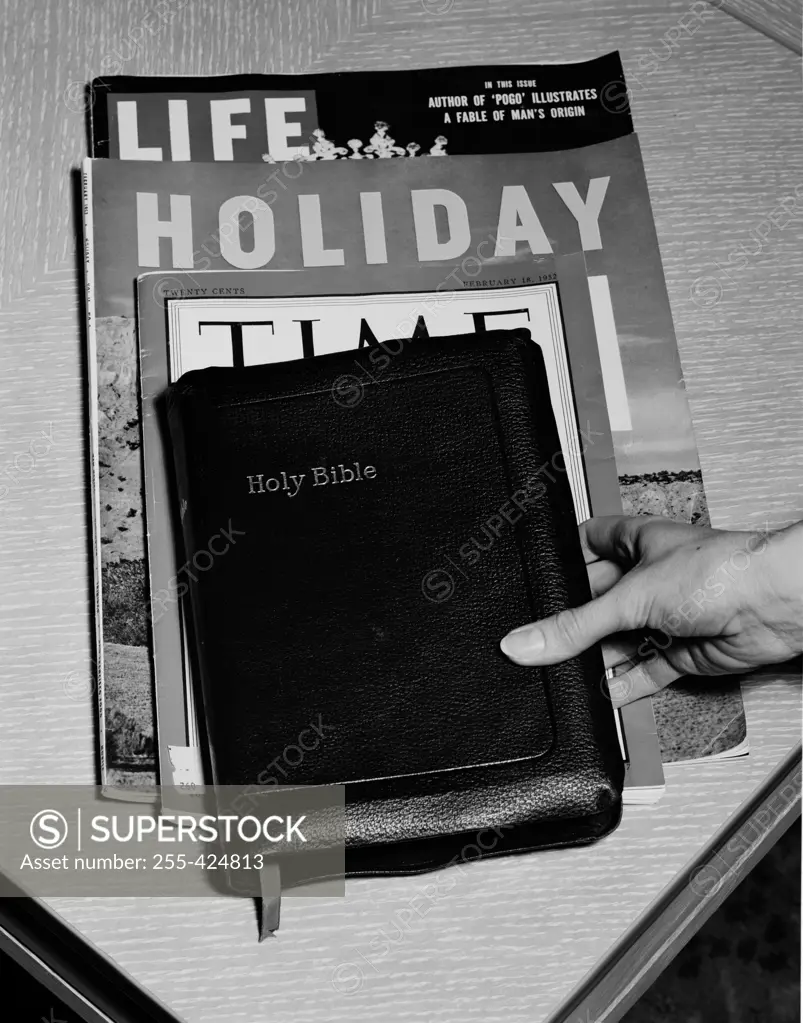 Hand, Bible and magazines