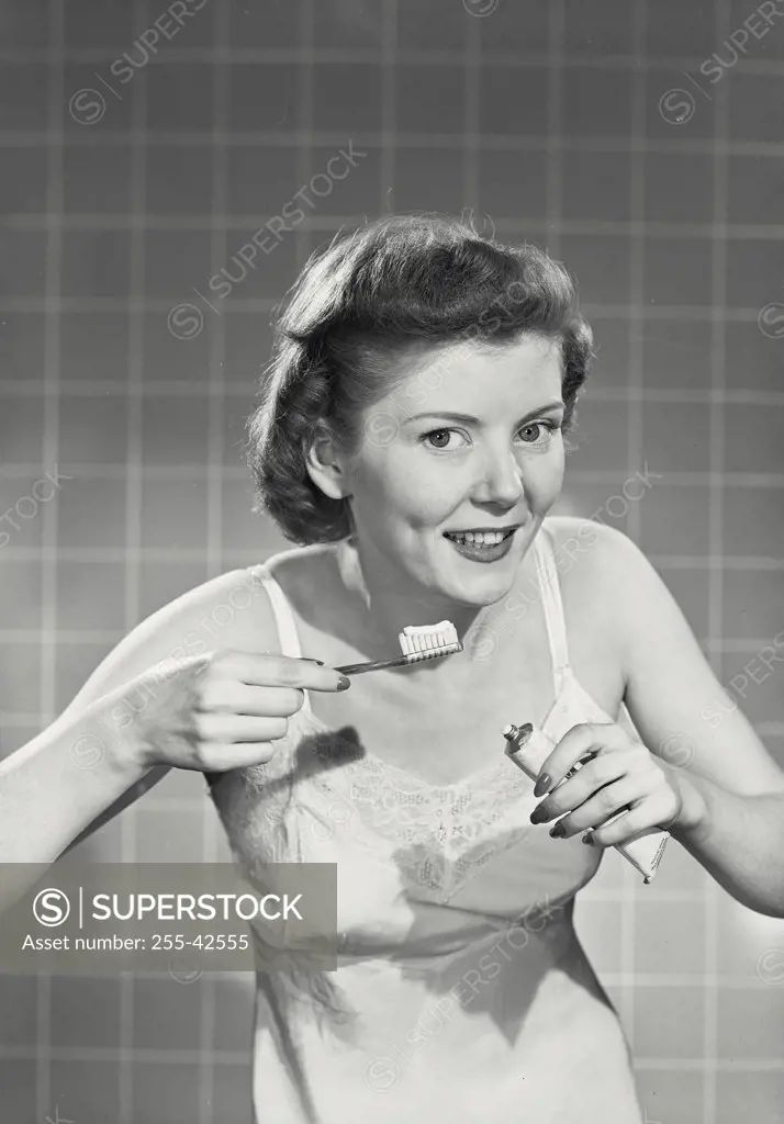 Vintage photograph. Woman with toothbrush and toothpaste