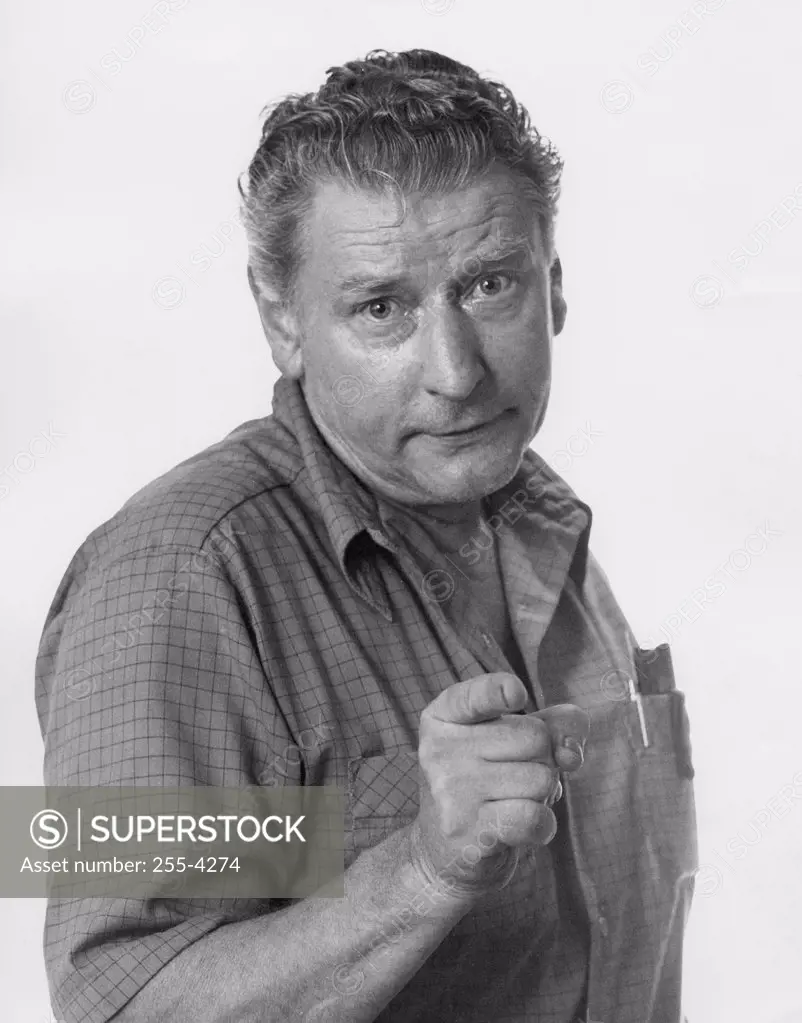 Pointing mature man looking at camera, portrait