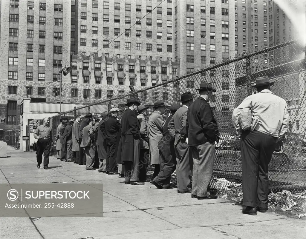 Vintage Photograph. Crowd watching excavation from behind chain link fence for the new Socony Vacuum Building at Third Avenue between 41st and 42nd Streets, New York City