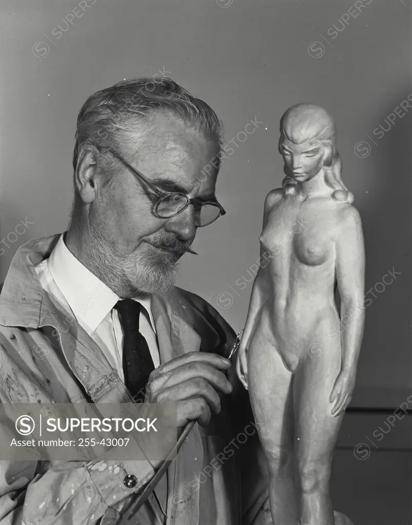 Vintage Photograph. Close-up of a senior man carving a statue