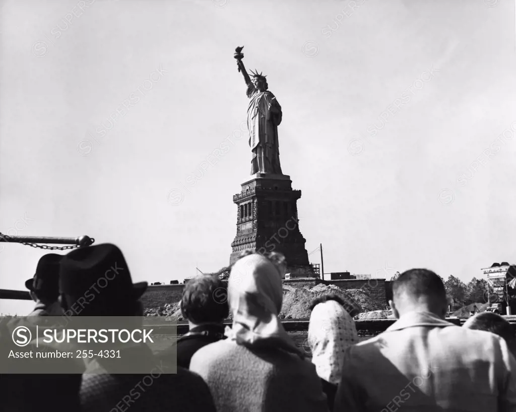 Tourists looking at a statue, Statue of Liberty, New York City, New York, USA