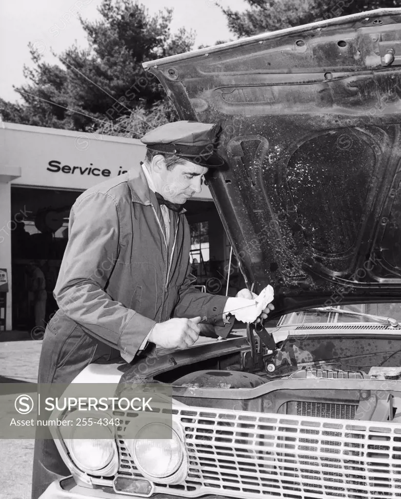 Auto mechanic repairing a car at a service station