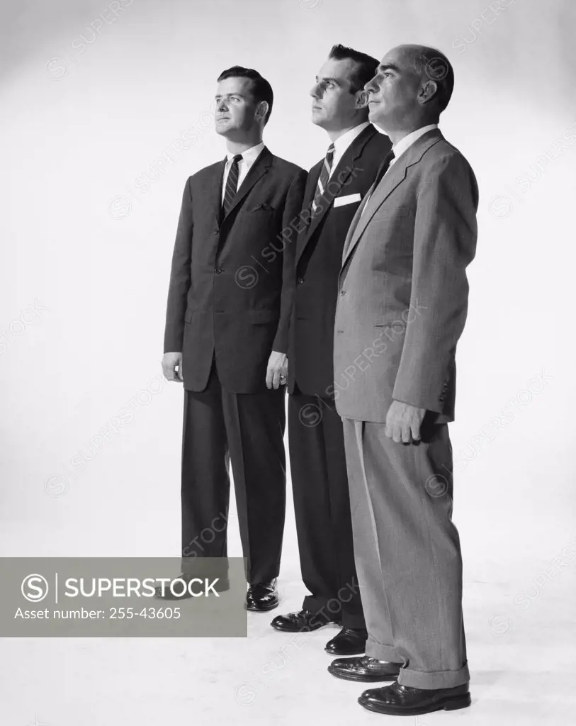 Side profile of three businessmen standing side by side