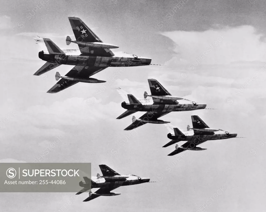 Low angle view of four fighter planes flying in formation, F-100 Super Sabre