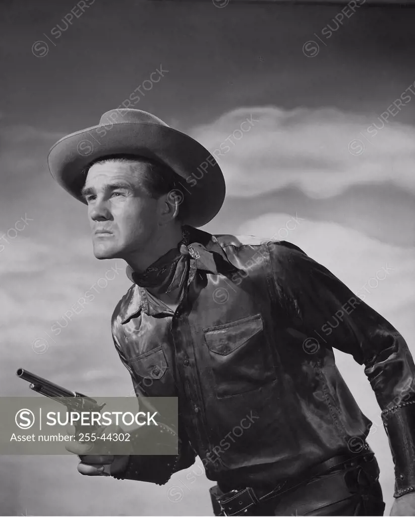 Side profile of a cowboy holding a handgun