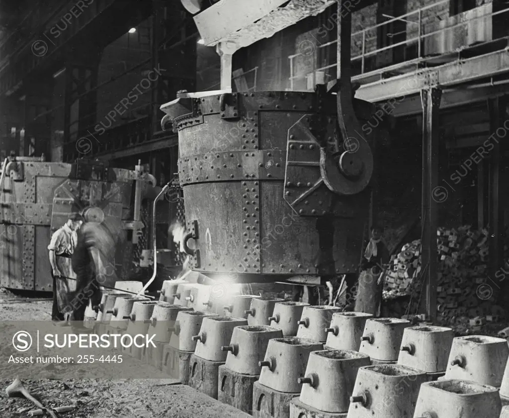 Vintage photograph. Molten steel running into three and a half ton moulds at British steel factory