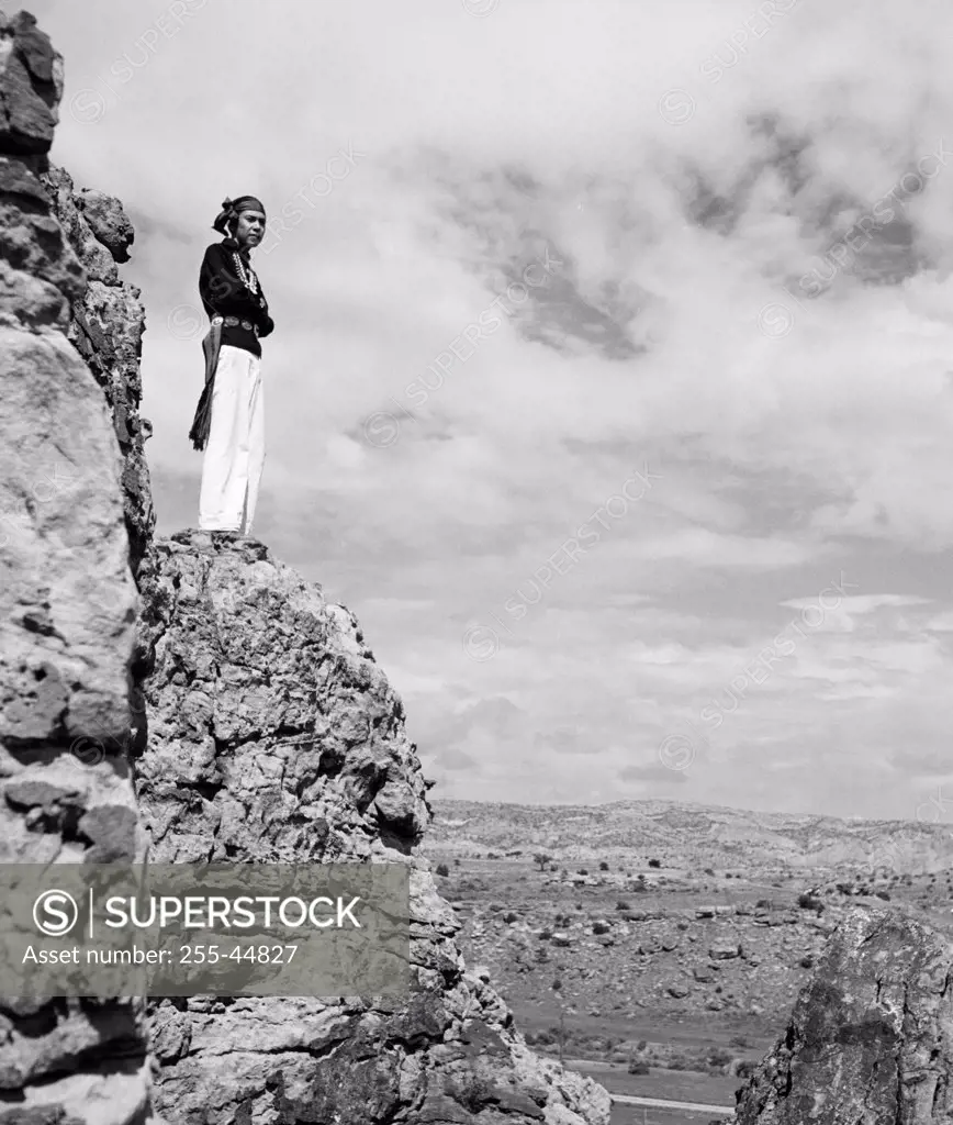 Hopi man standing on a rock