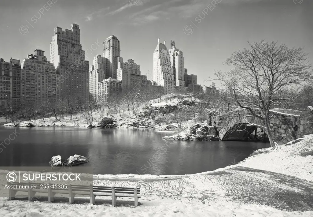 Vintage photograph. View of pond toward Central Park South from Central Park after light snowfall, New York City