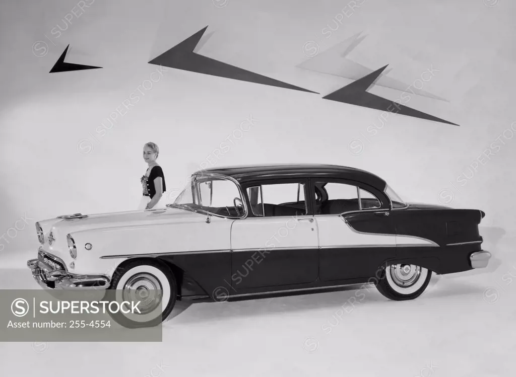 Woman standing near a 1955 Oldsmobile Super 88