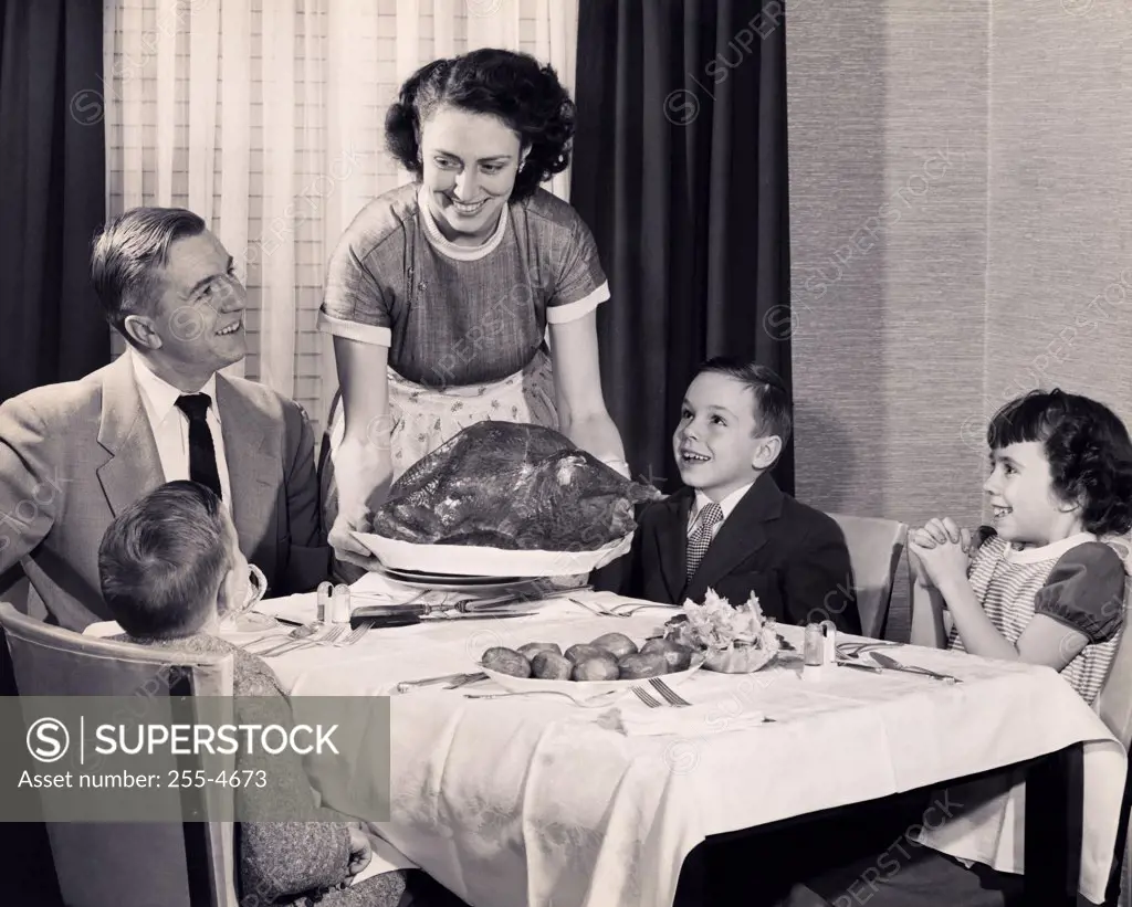 Mother serving a turkey on a platter