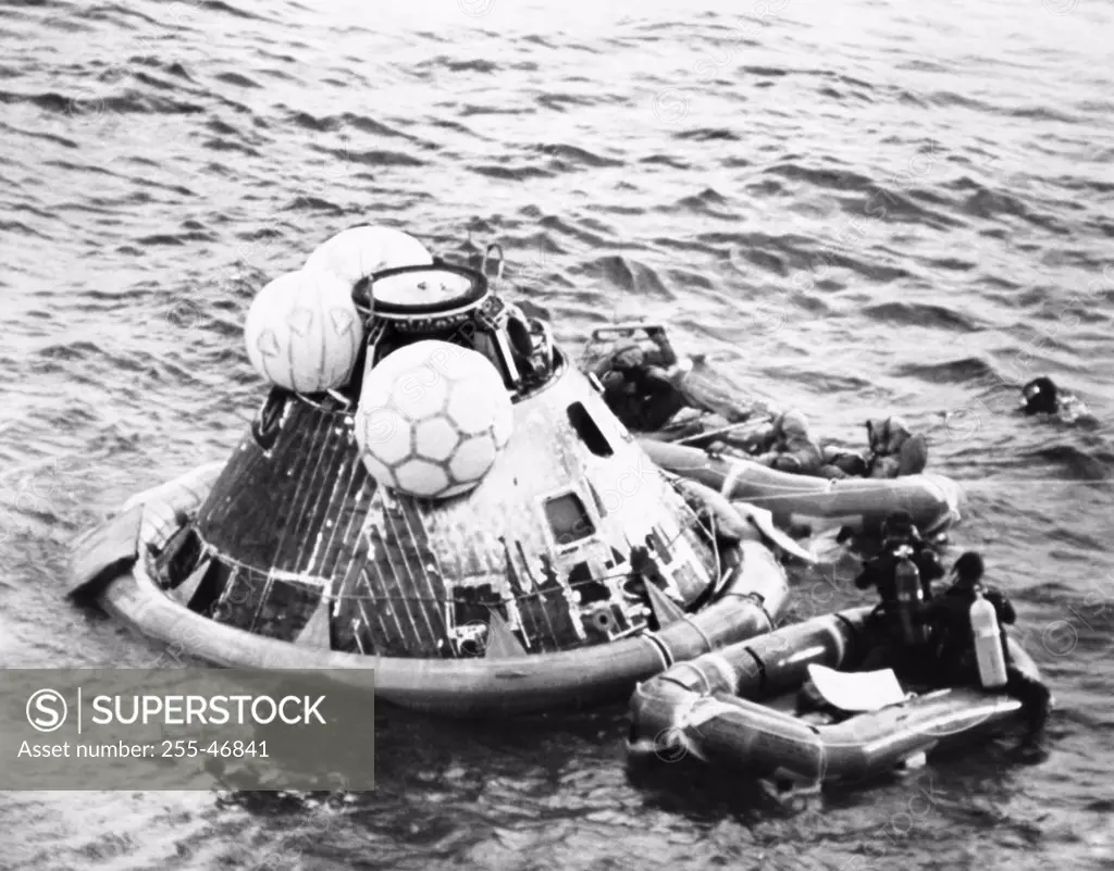 High angle view of a rescue squad near a space capsule in the sea
