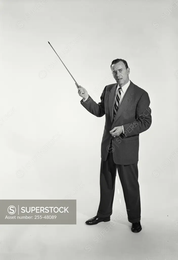 Vintage Photograph. Man in suit and tie holding pointing stick on white background. Frame 1