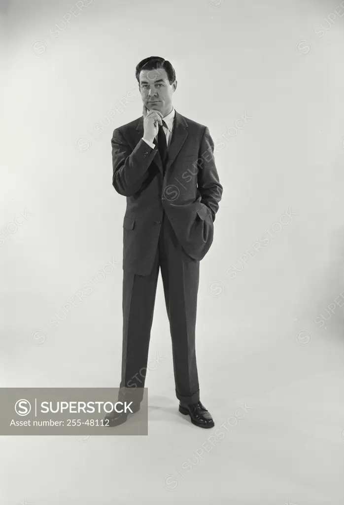 Vintage Photograph. Man wearing suit and tie full length view on white background, Frame 5