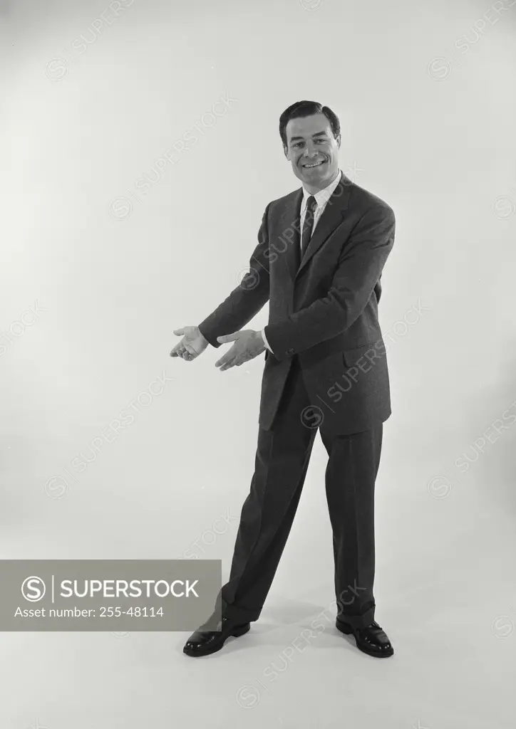 Vintage Photograph. Man wearing suit and tie full length view on white background, Frame 10