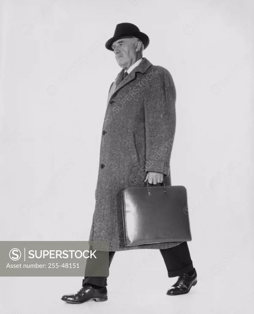Side profile of businessman carrying briefcase
