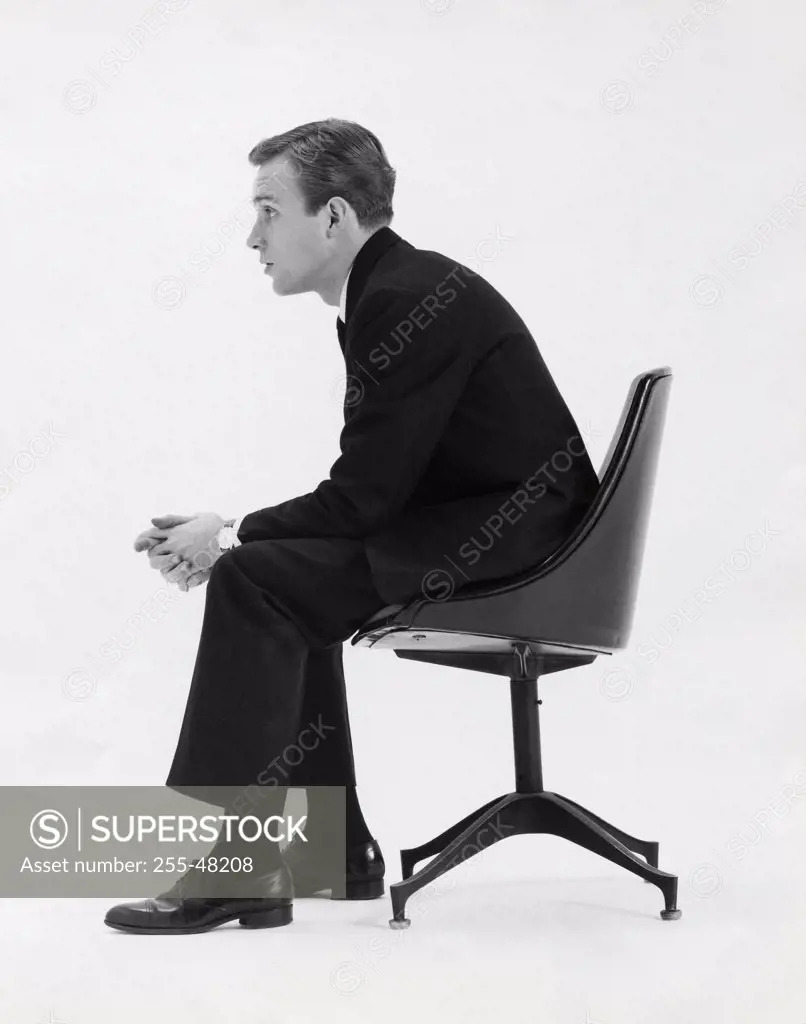 Side profile of a businessman sitting in an office chair