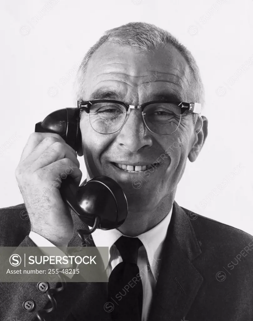 Senior businessman talking on telephone
