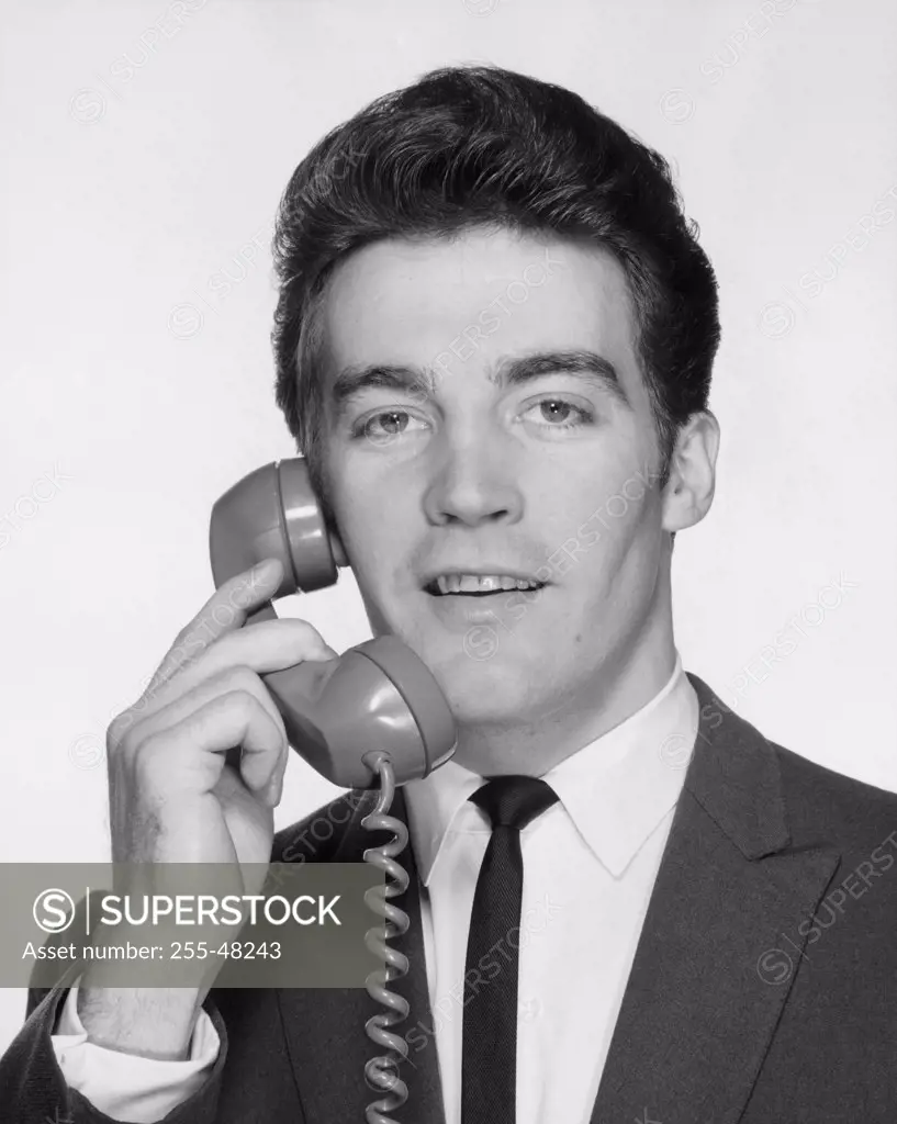 Young businessman using telephone