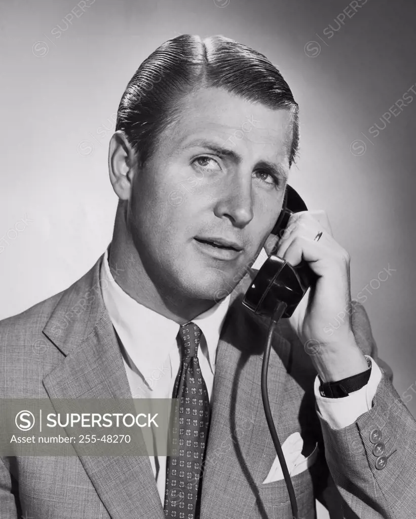 Close-up of businessman using telephone