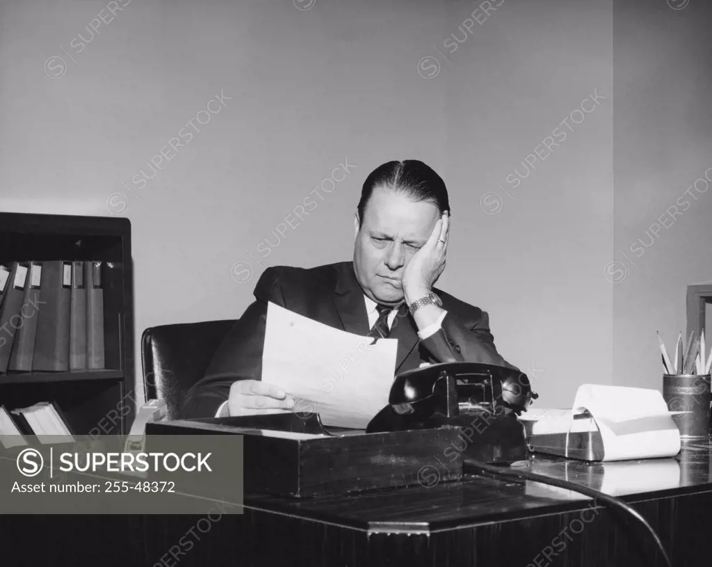Businessman reading a document in an office