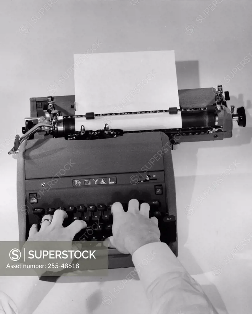 Close-up of a person typing on a typewriter