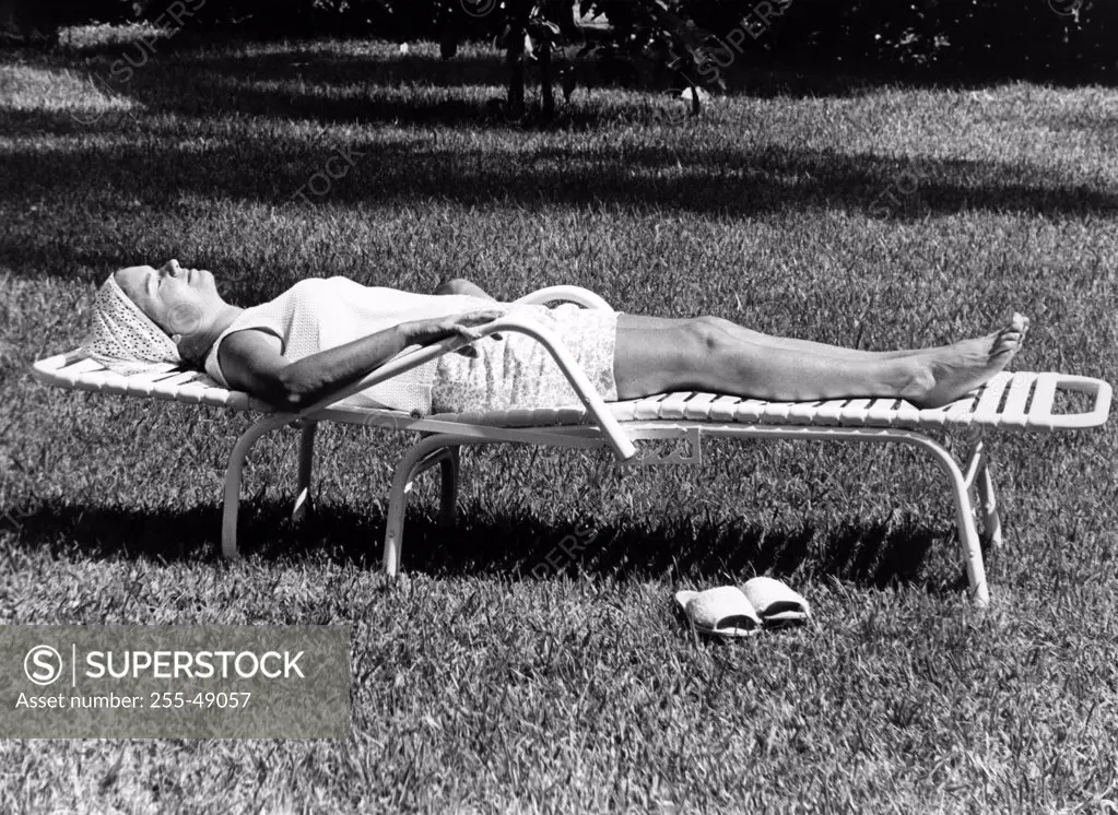 Woman sunbathing in backyard