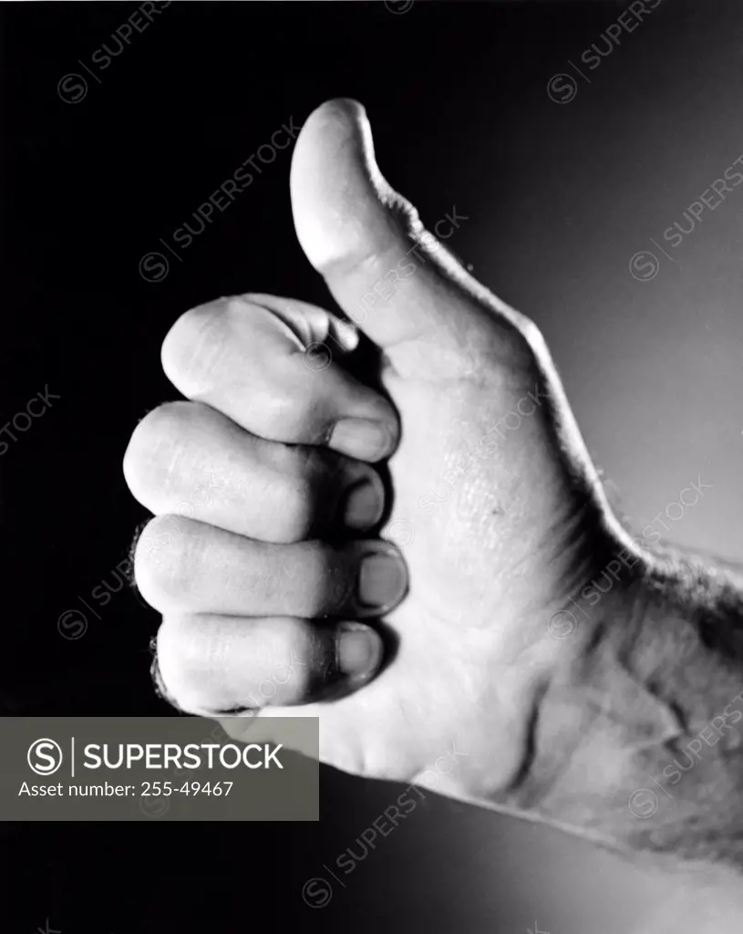 Studio shot of male hand with thumb up