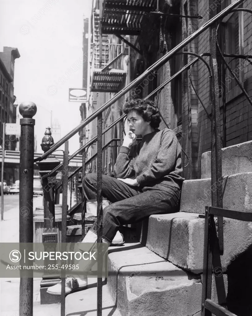 Woman sitting on front stoop