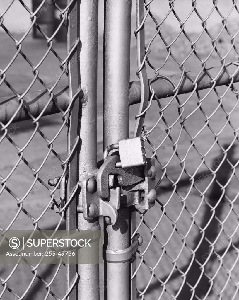 Close-up of a gate locked with a padlock