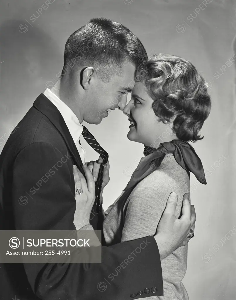 Vintage Photograph. Man and woman holding each other close, touching noses looking at each other