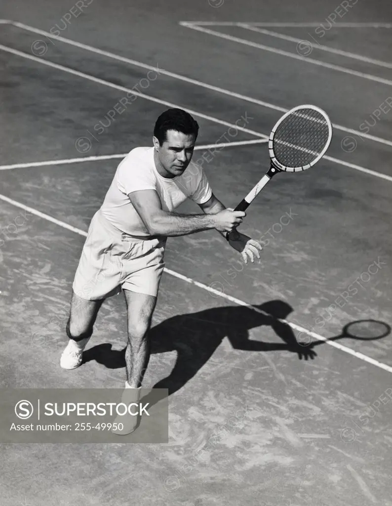 Young man playing tennis on tennis court
