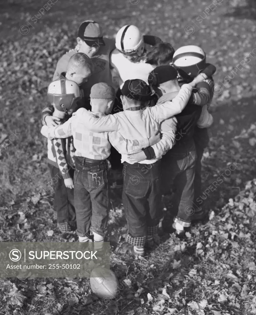 High angle view of boys standing in a huddle