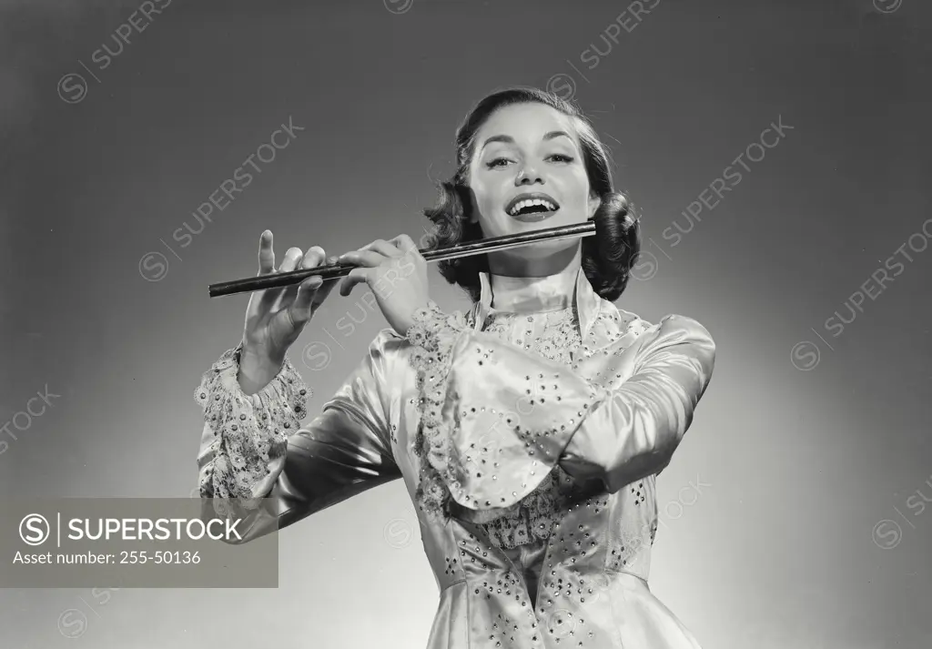 Vintage Photograph. Woman in long gown playing the flute. Frame 2