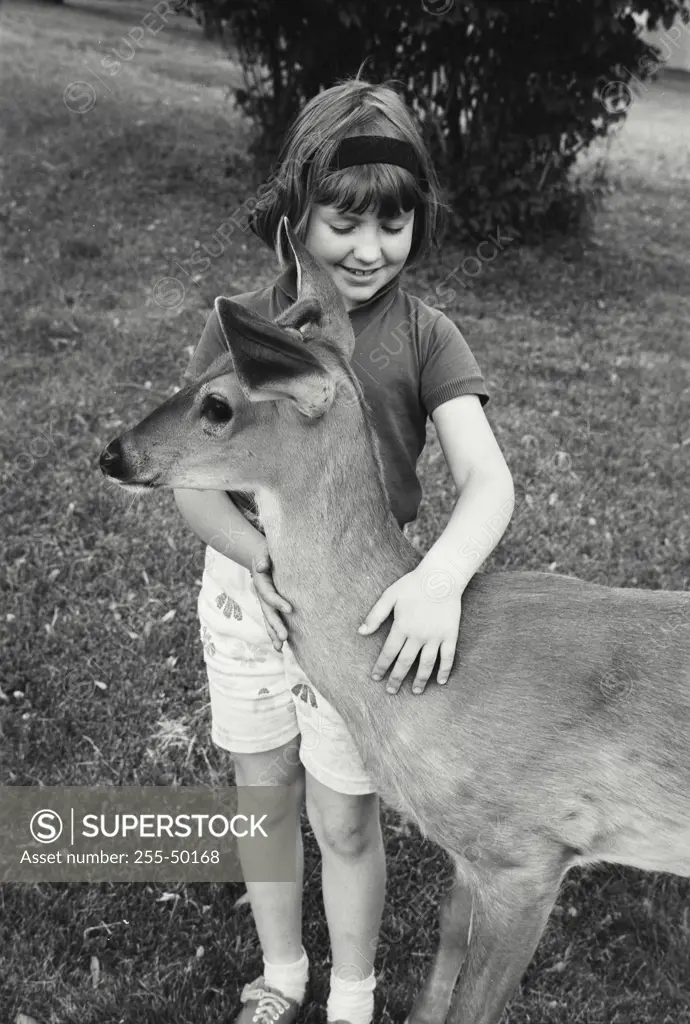 Vintage Photograph. Girl with pet deer