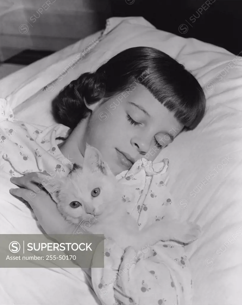 Close-up of a girl sleeping with a cat