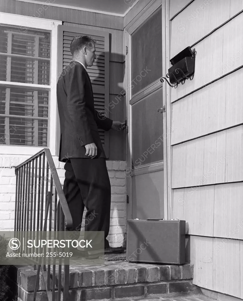 Salesman ringing the doorbell of a house