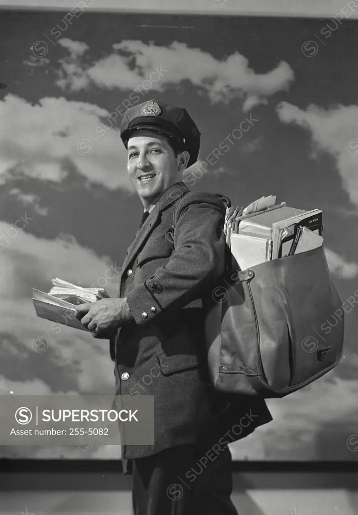 Vintage Photograph. Mailman holding bag of mail and a letter. Frame 4