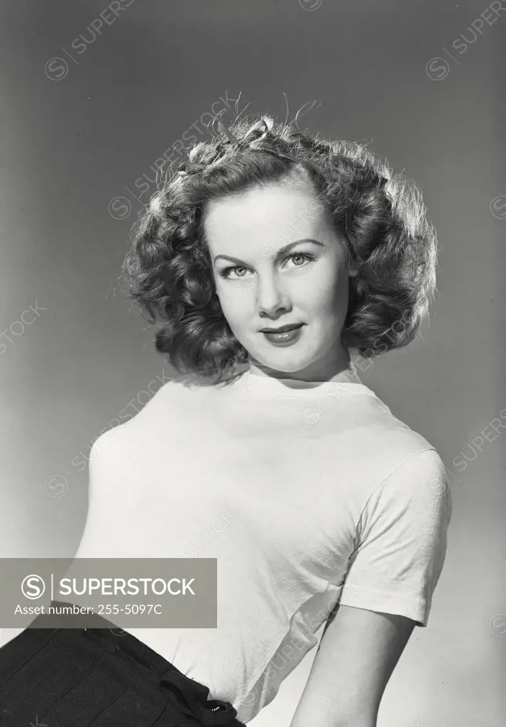 Vintage photograph. Portrait of young woman in t-shirt smiling at camera
