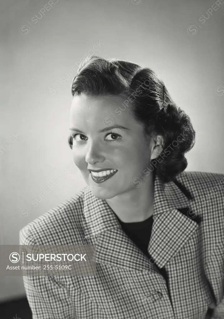 Vintage photograph. Brunette woman smiling wearing gingham plaid pattern jacket