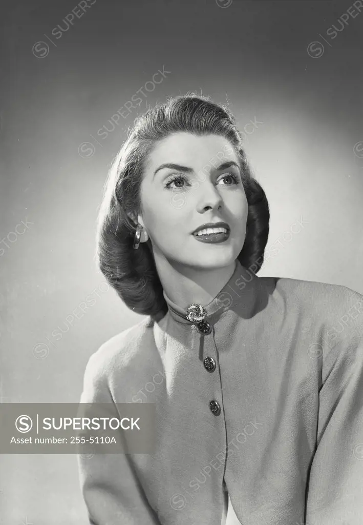 Vintage photograph. Portrait of brunette woman wearing high neck blouse with brooch