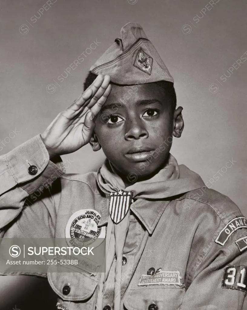 Portrait of a boy scout saluting