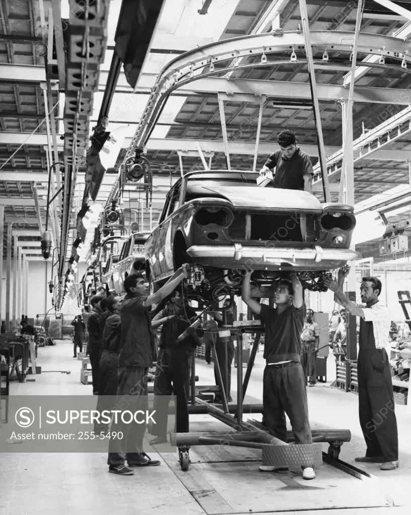 Workers working on assembly line of cars, Egypt