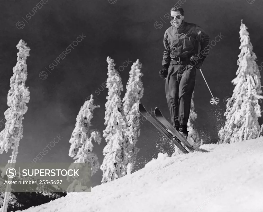 Low angle view of a mid adult man skiing on snow