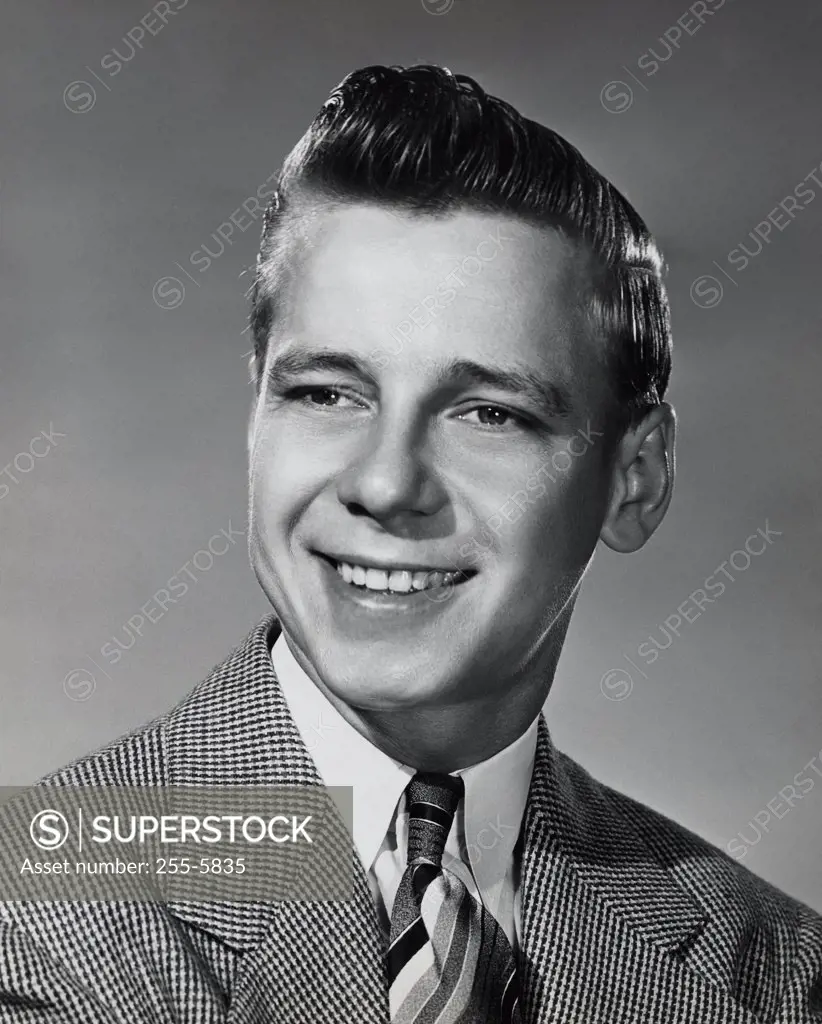 Vintage Photograph. Young man in suit and tie smiling