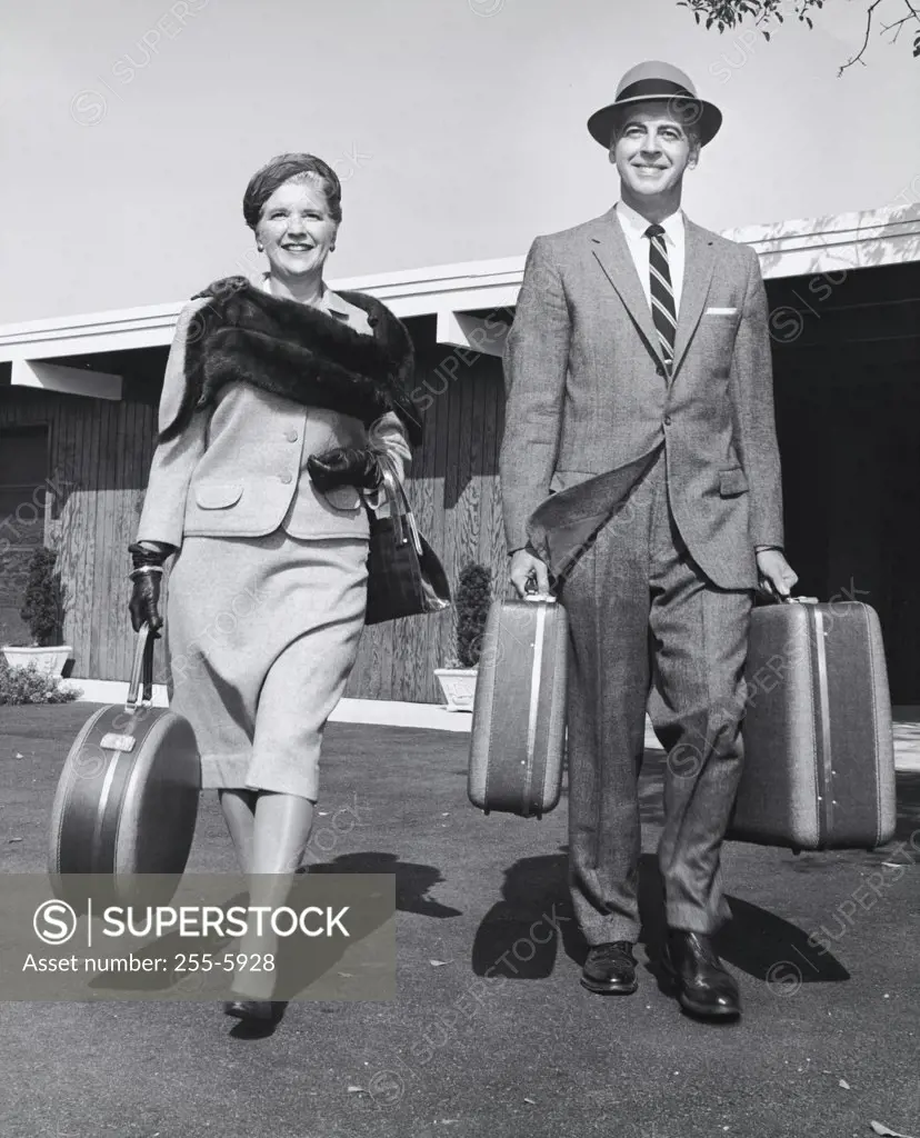 Mature couple carrying their luggage