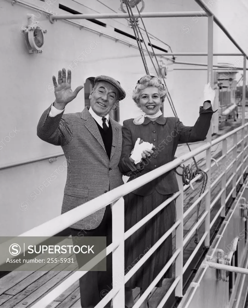 Portrait of senior couple waving
