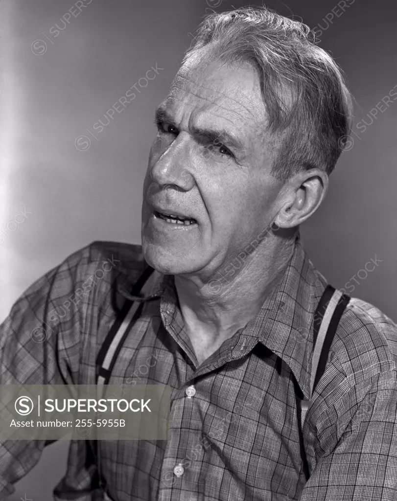 Portrait of mature man in shirt and suspenders