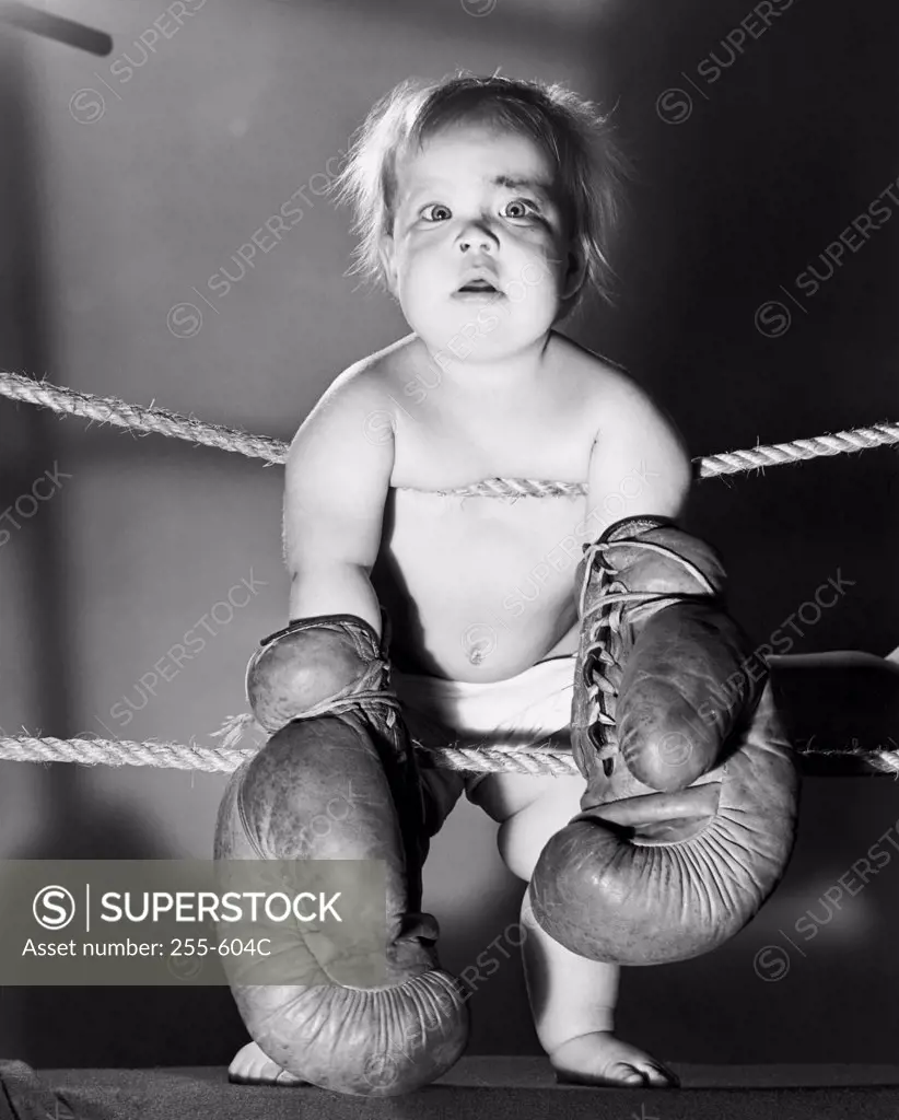Portrait of a baby wearing boxing gloves